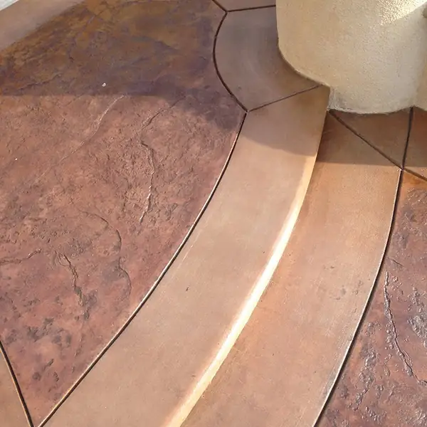 Curved stained patio with a textured contrasting border