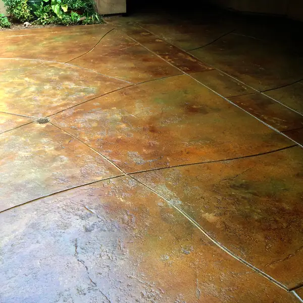 Mottled orange and green acid-stained patio surface