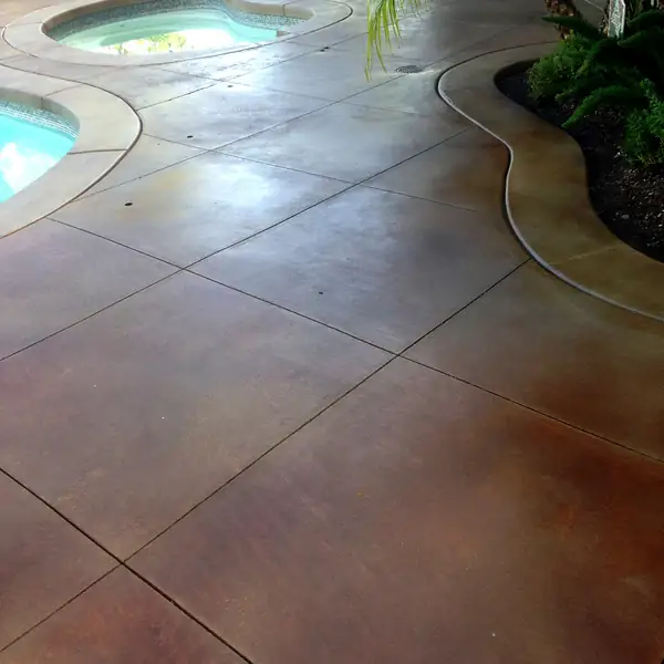 Pool and spa deck stained and scored into large tiles