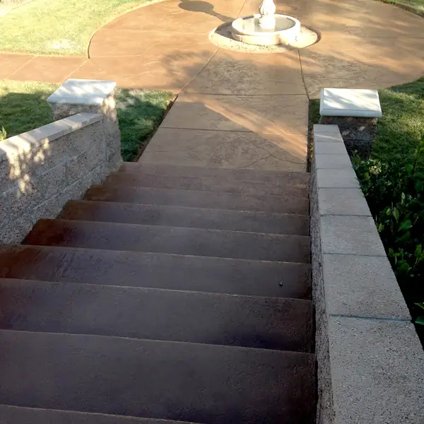 Stained steps leading down to a courtyard fountain