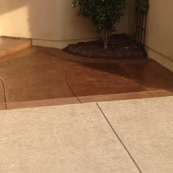 Warm stained entry walkway curving to a front door