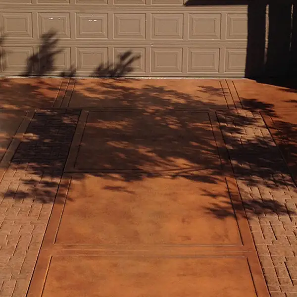 Rust stained patio in a wood-plank pattern beside a garage door