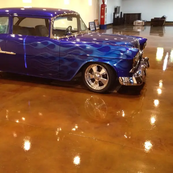 Classic hot rod reflected in a mirror-gloss copper-stained garage floor