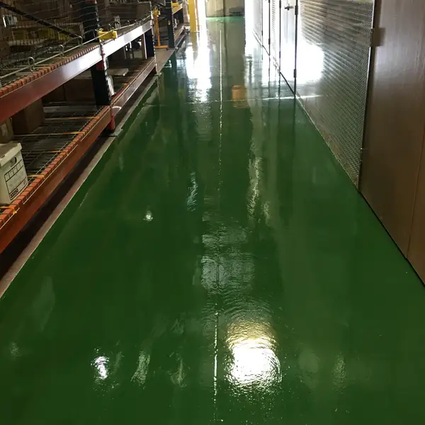 Dark green epoxy aisle running between warehouse racking