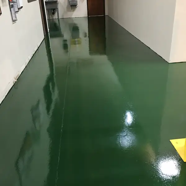 Glossy dark green epoxy corridor between white warehouse walls