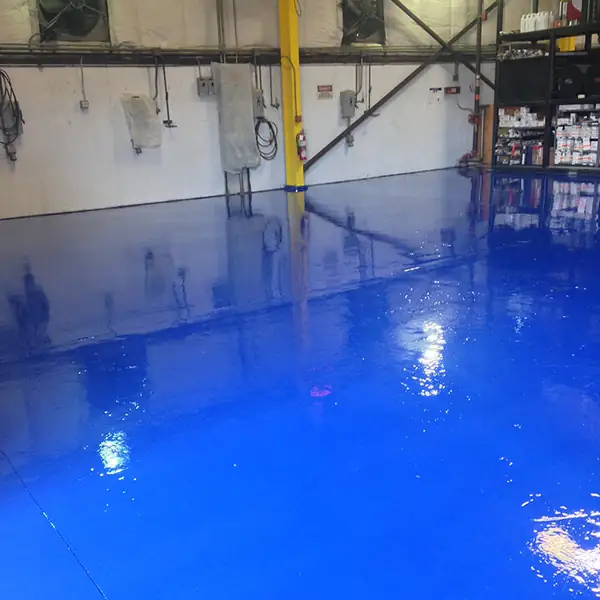 Wet-look blue epoxy floor in an industrial workshop