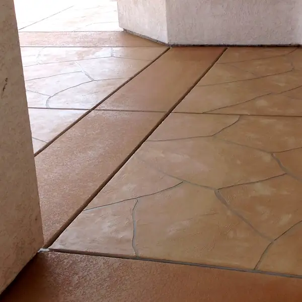 Tan flagstone-pattern microtopping laid over an existing patio slab