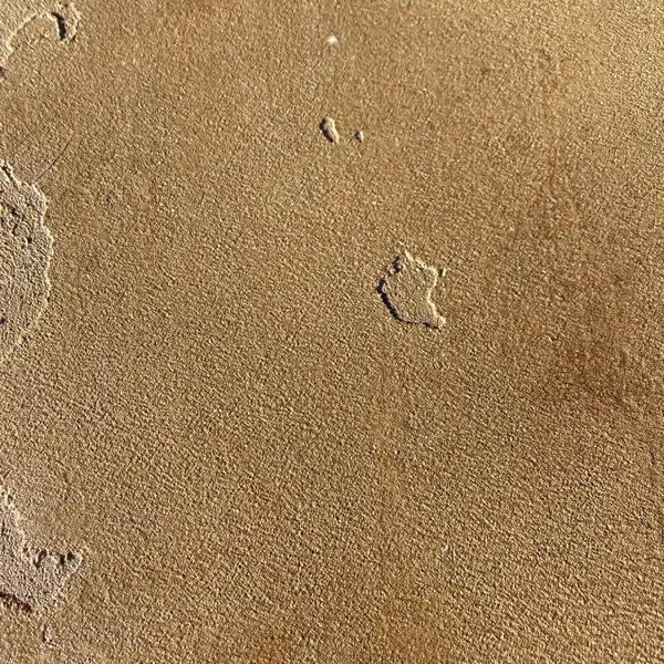 Close view of a knockdown texture in a gold microtopping