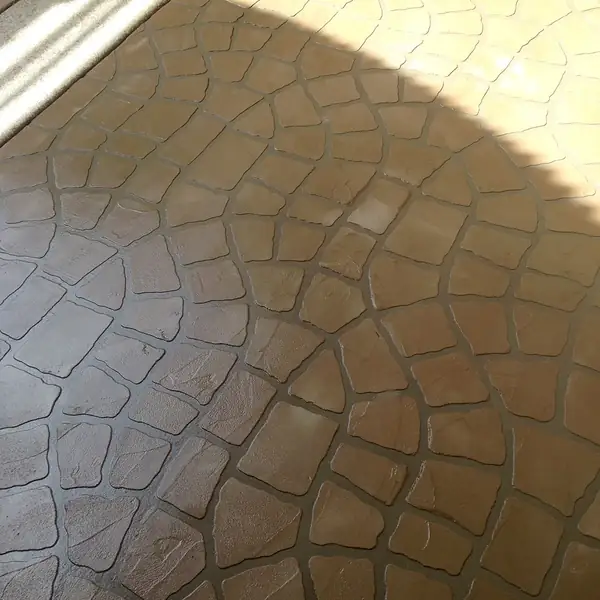 Close view of a stamped stone-pattern overlay in warm terracotta