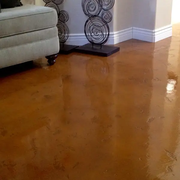 Copper stained and polished concrete floor in a furnished living room