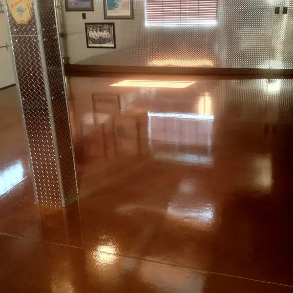 Polished copper stained concrete running down a residential hallway