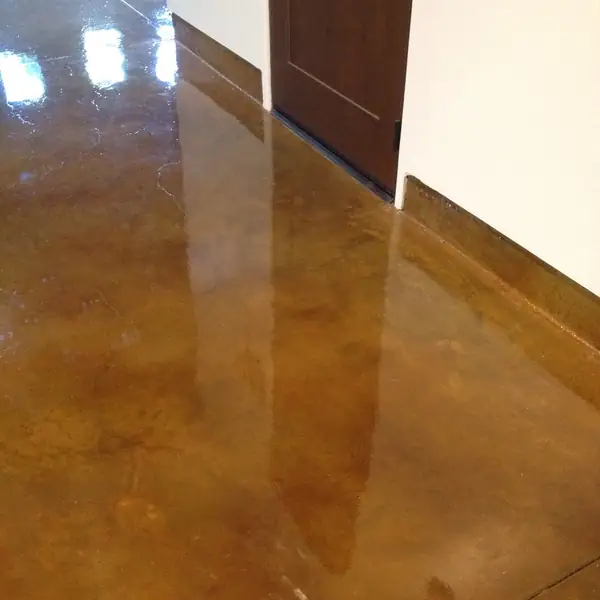 Amber stained concrete hallway floor reflecting the doorways