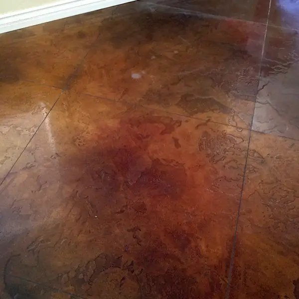 Mottled red and brown acid stained concrete floor