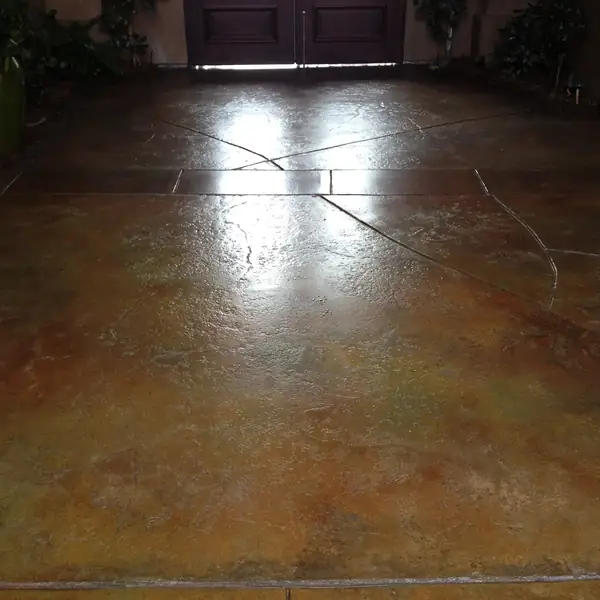 Mottled tan stained entry floor with score lines and double doors