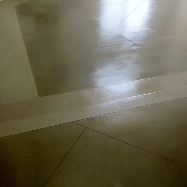 Polished tan concrete floor with a lighter inset border