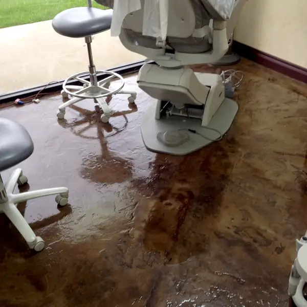 Stained concrete floor in a dental surgery beneath the chair