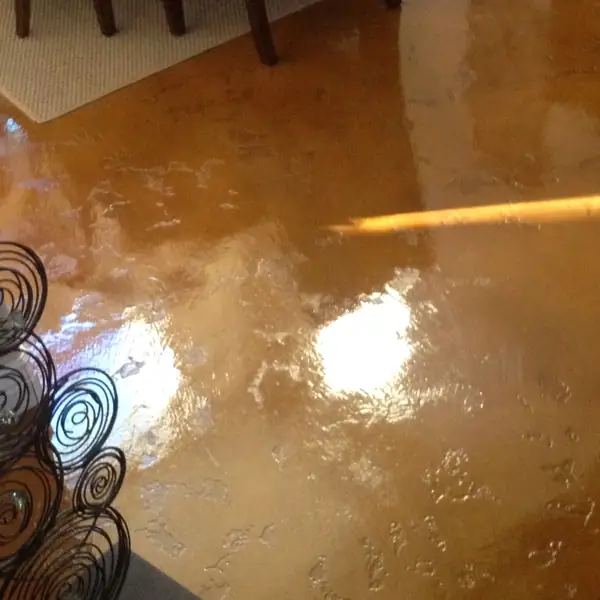 Copper stained interior concrete floor catching the light