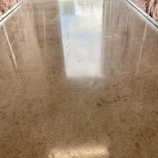 Polished concrete floor in warm gray with light reflections