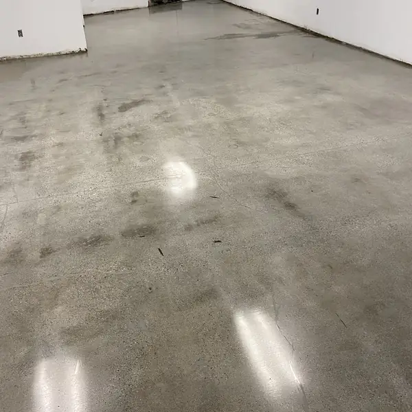 Mottled gray polished concrete floor in an empty commercial space