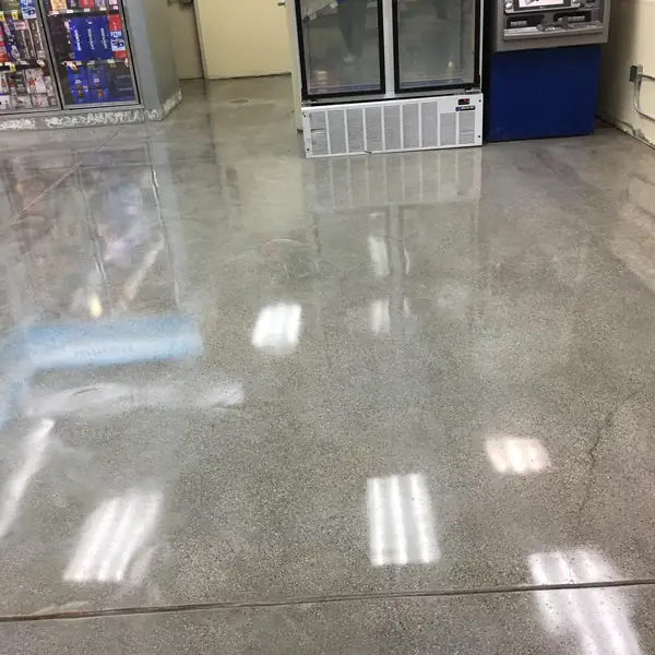 Polished concrete floor reflecting the lights in a convenience store aisle