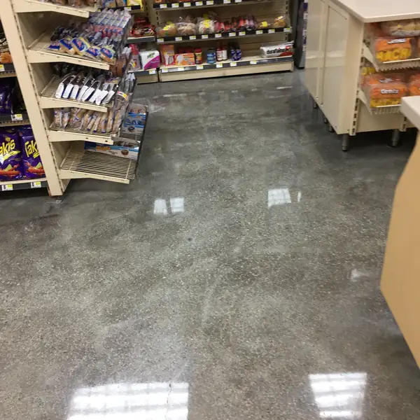 Polished concrete floor running beneath store shelving