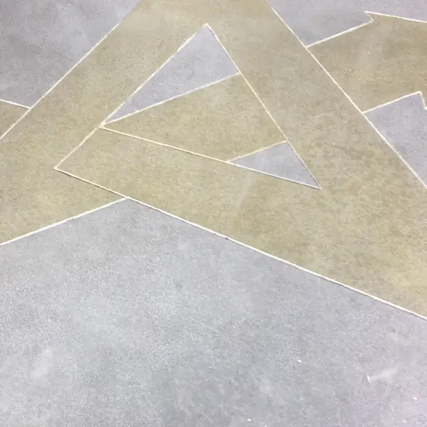 Gold stained geometric graphic set into a polished concrete floor