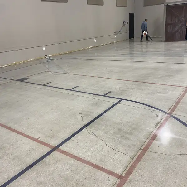 Polished hall floor with red and black saw-cut court lines