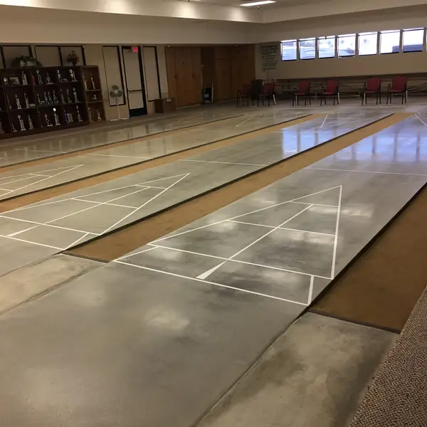 Polished concrete floor with white court lines in a community hall