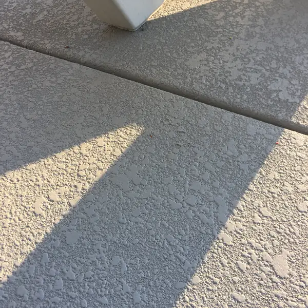 Cream knockdown textured deck with a shadow line across it