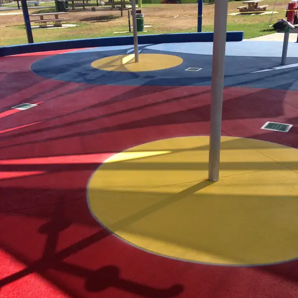 Red and yellow splash pad coating with play posts and circular targets
