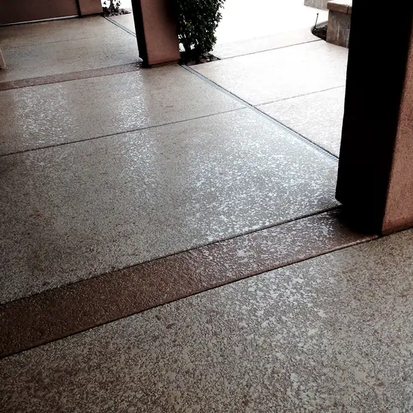 Gray flake textured deck under a covered patio