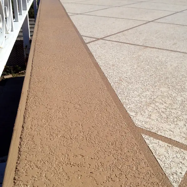 Close view of the sand texture in a tan cool deck walkway