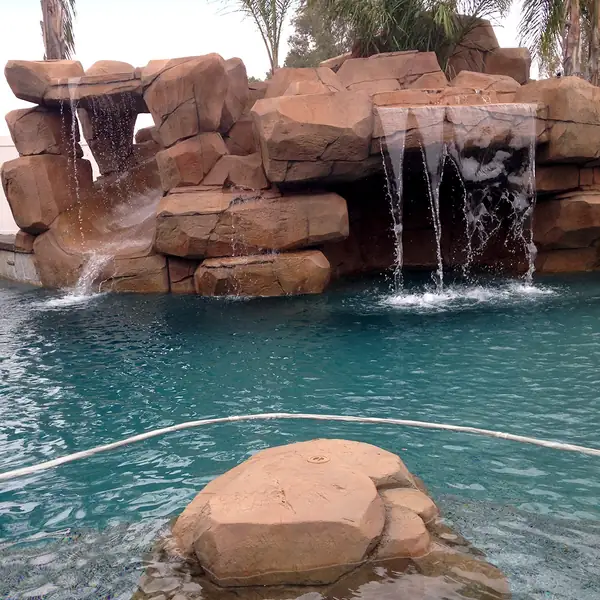 Close view of water running over restained faux rock