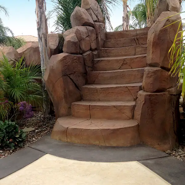Restained boulder staircase climbing between planted beds